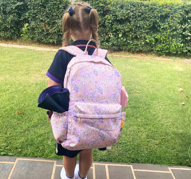 girl wearing blossom junior backpack