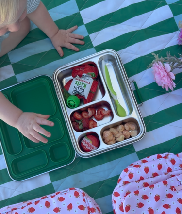 bento 5 stainless lunch box in green colour with food and snacks, and strawberry fields backpack and lunch bag